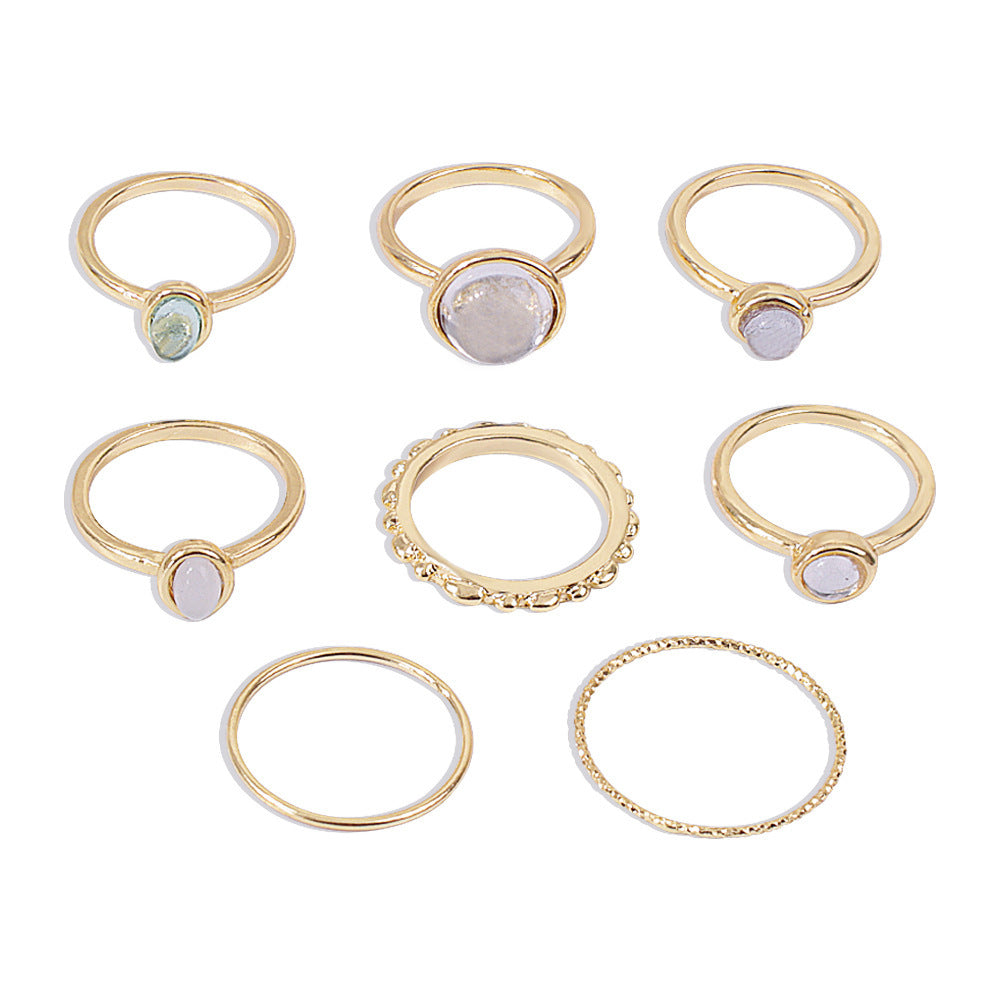 Colorful stone metallic finger rings set for women with geometric designs.