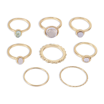 Colorful stone metallic finger rings set for women with geometric designs.