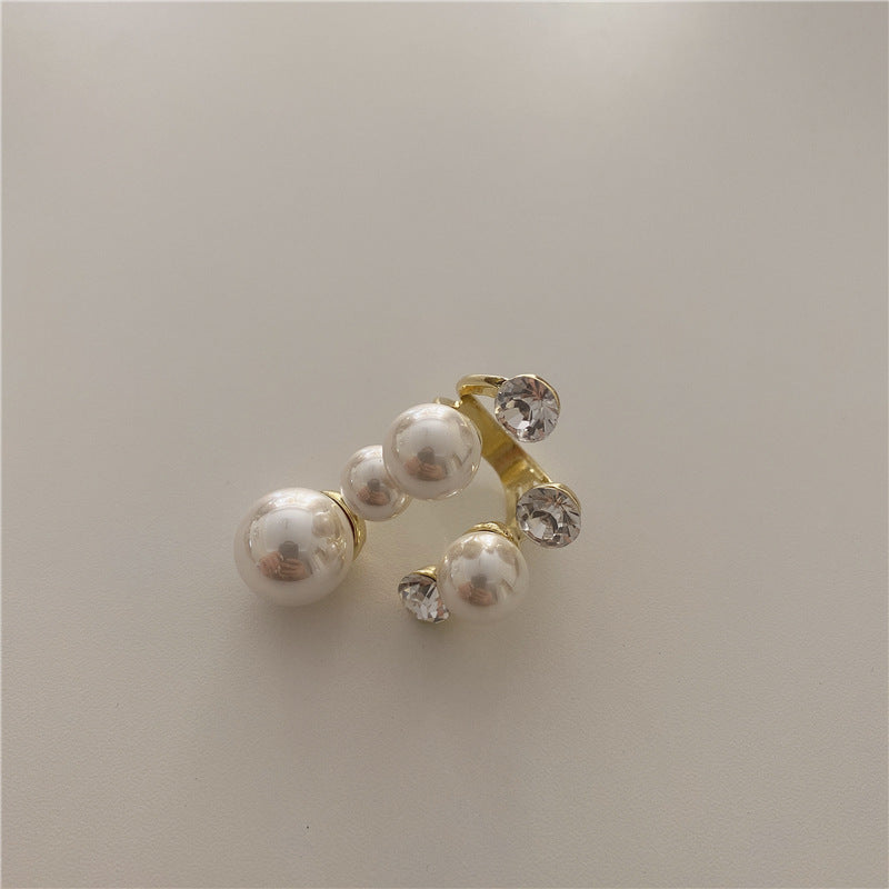 Elegant multi pearl ring for women with rhinestone accents.