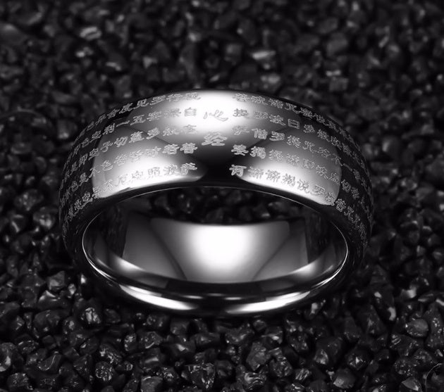 dome ring with engraved design on black textured background