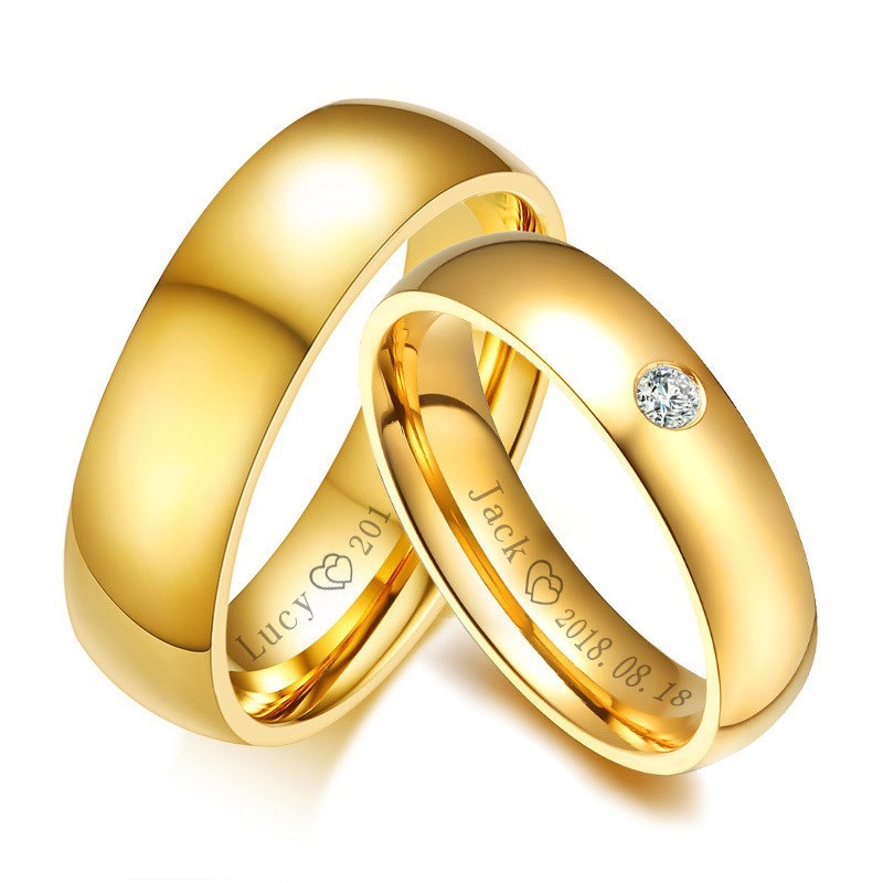 Golden stainless steel couple rings with personalized engraving, matching jewelry for couples.