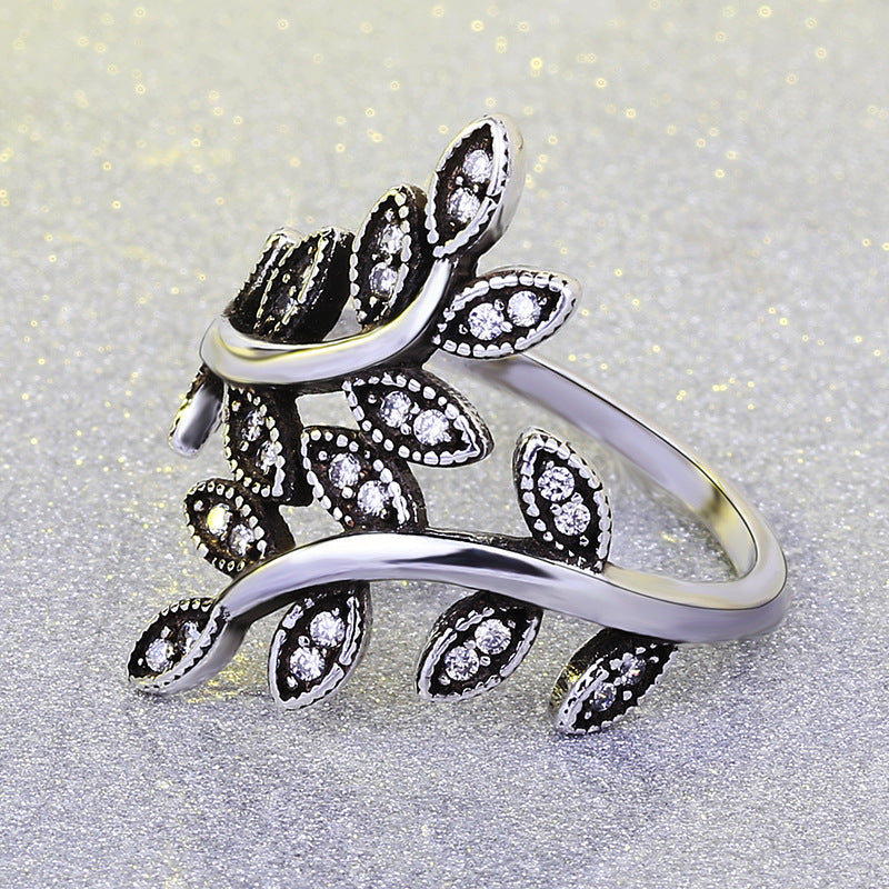 Life Rings Black Vintage Ring with intricate tree design on silver background.