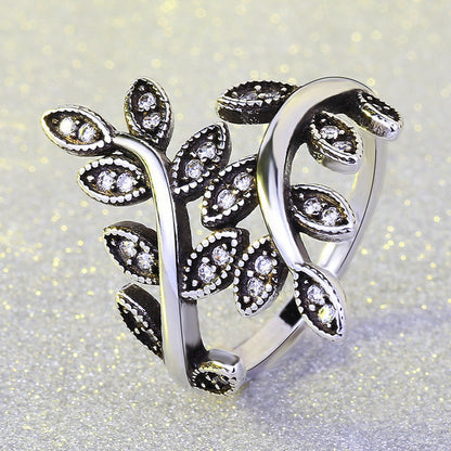 Black vintage ring with intricate tree design, elegant and durable accessory.