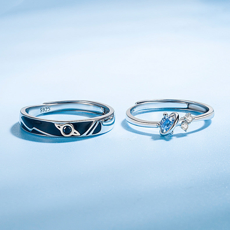 Dream Planet couple rings in sterling silver with geometric design on blue background.