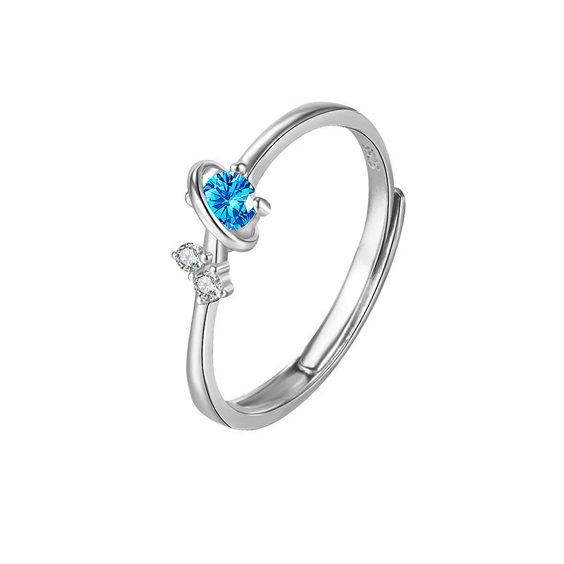 Dream Planet couple ring in silver with blue and clear gemstones, unisex fashion accessory.