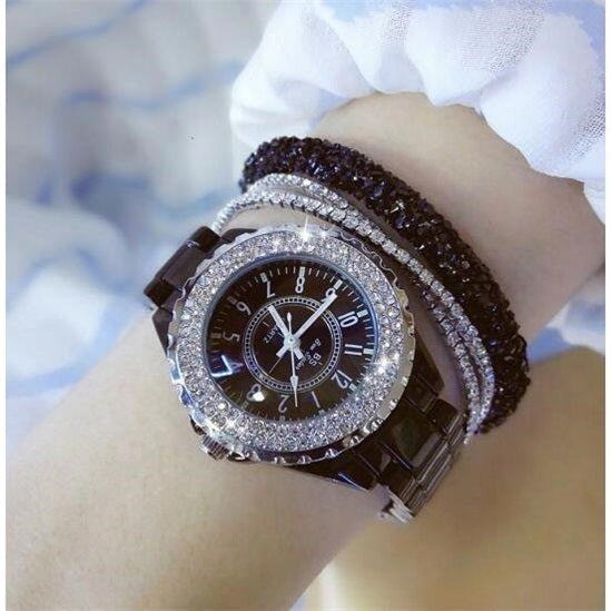 Mechanical watch with a round dial and bracelet design, styled on a female wrist.