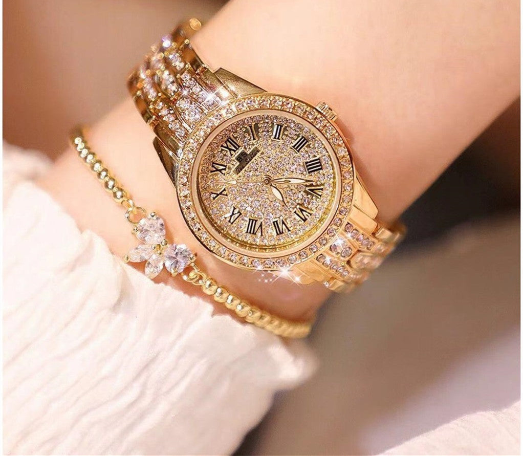 Mechanical ladies watch with gold bracelet and ornate dial.