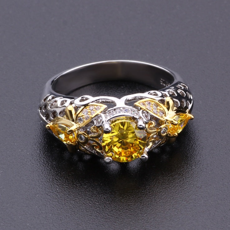 Alloy geometric zircon ring with intricate detailing and yellow stone.