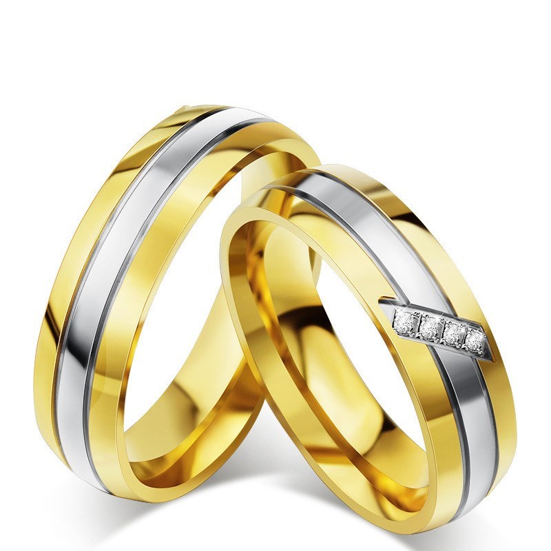 Matching titanium steel couple rings with gold and silver geometric design.