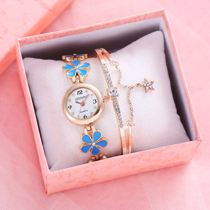 Ladies petal patterned quartz watch bracelet set in a pink box with blue floral accents and jewelry buckle.