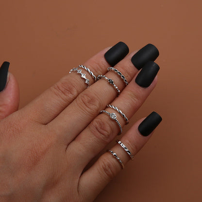 Leaf Crown Geometric Articulation Rings 6 Piece Set on hand with matte black nails.