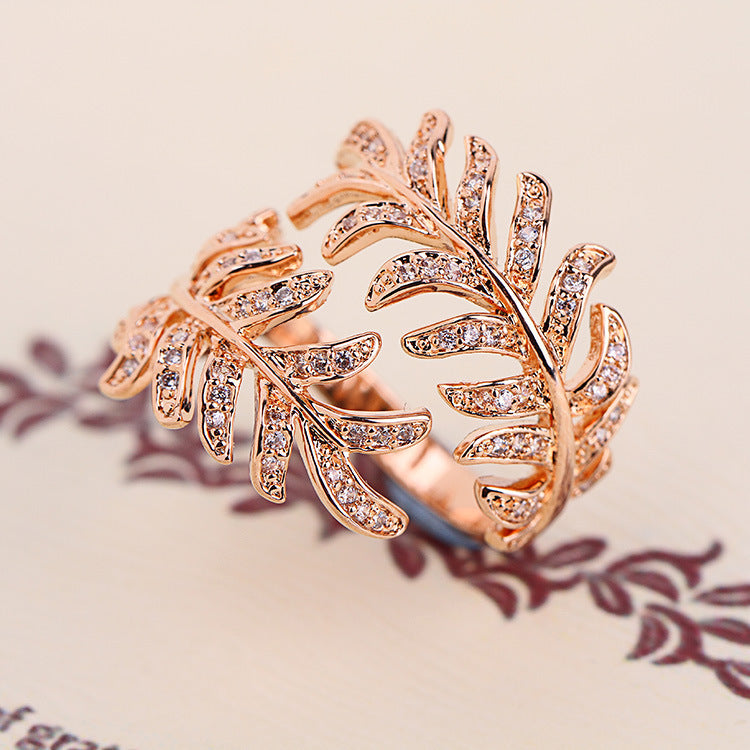 Mimosa leaves ring in alloy with intricate leaf details, adjustable size.