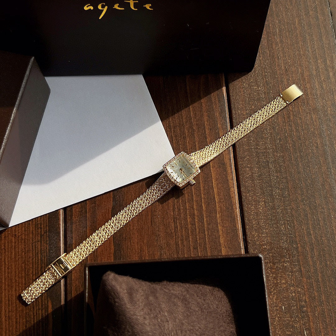 Zhonggu small golden watch with square face and stainless steel mesh strap.