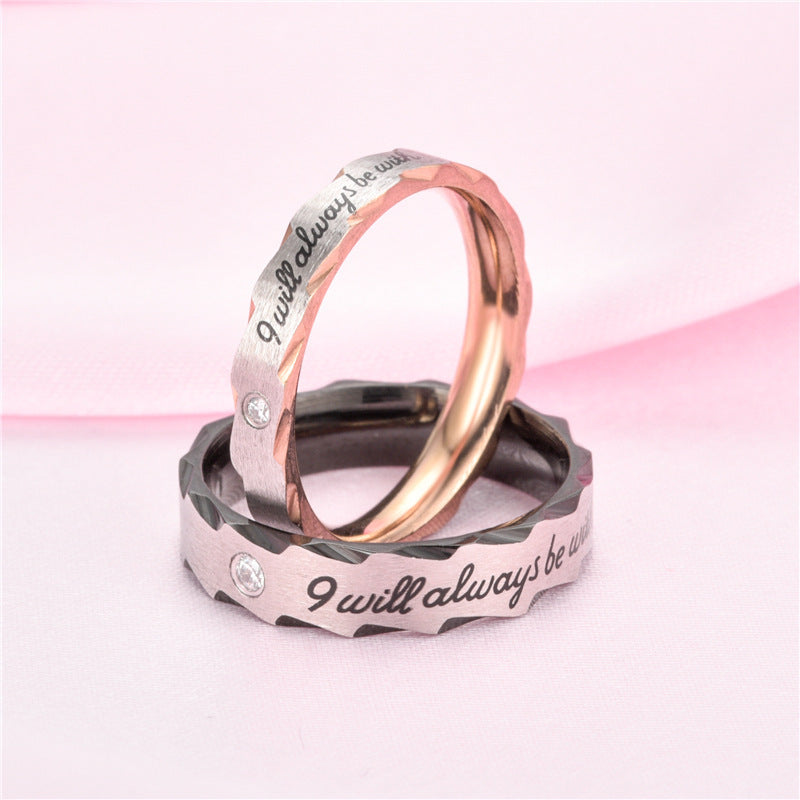 Stainless steel couple rings with floral motif and engraved message.