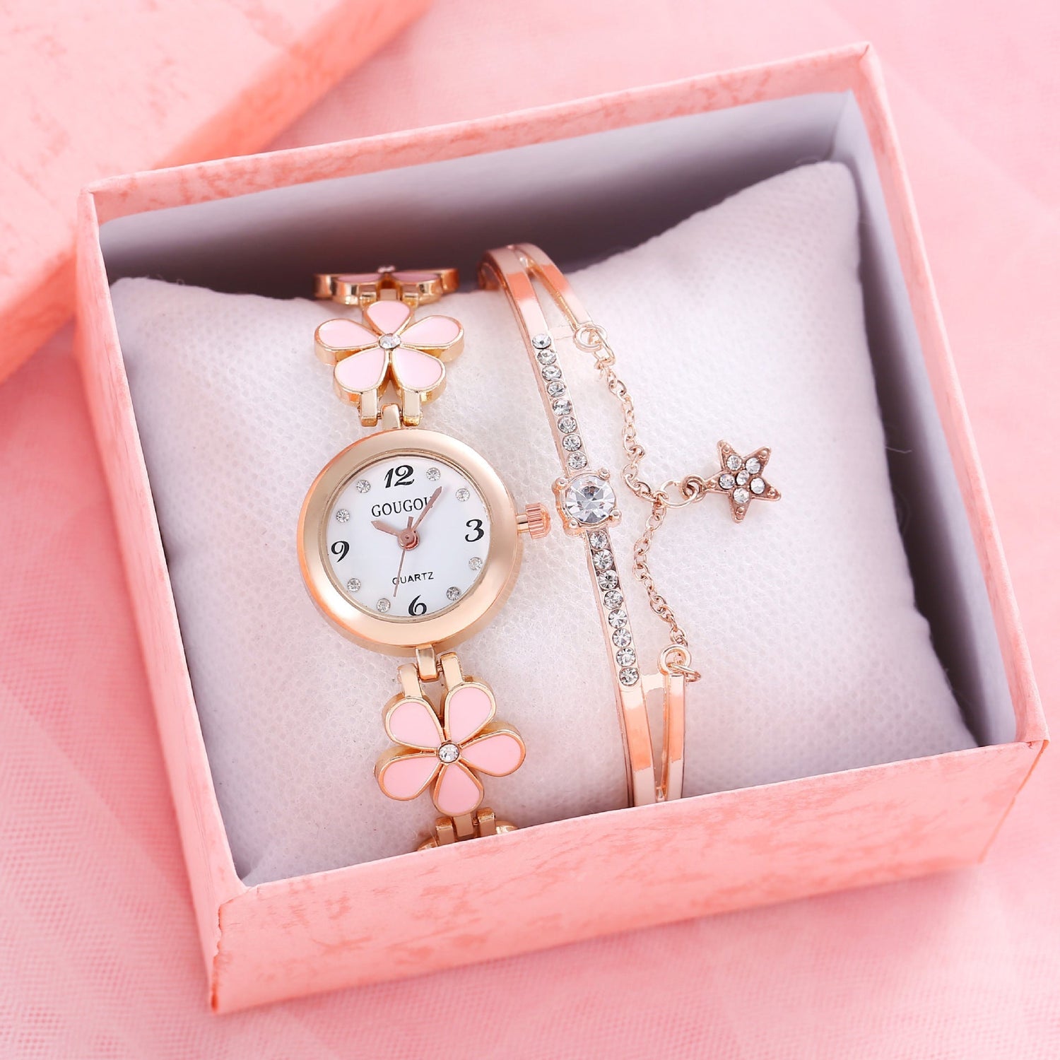 Ladies petal patterned quartz watch bracelet set in pink box.