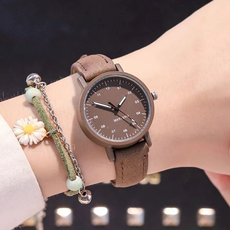 Korean simple antique Mori style watch with brown band on wrist.