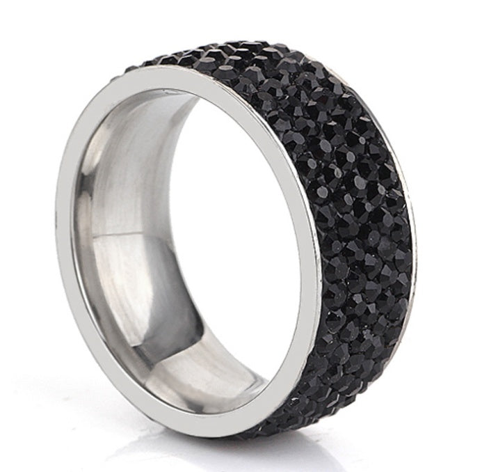 Stainless steel ring with black textured surface, available in sizes 6 to 9.