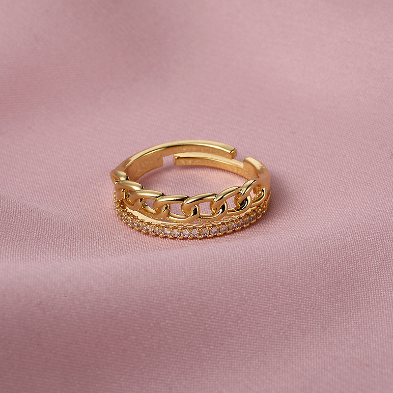 Versatile gold fashion ring with copper electroplating on pink fabric.