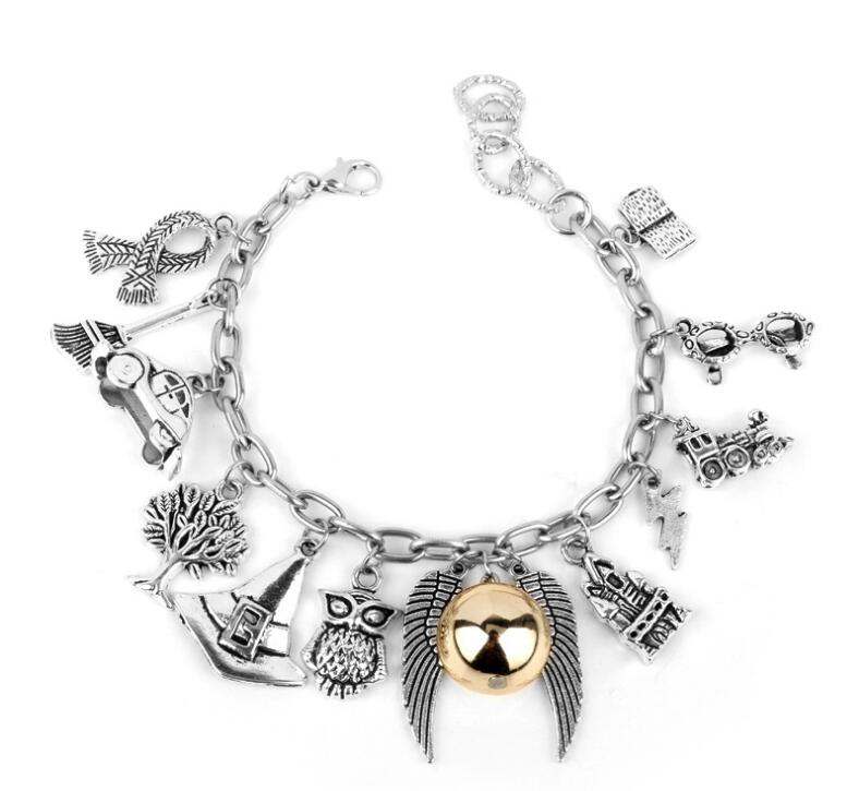 Angel wings bracelet in gold silver alloy featuring charms and intricate designs.