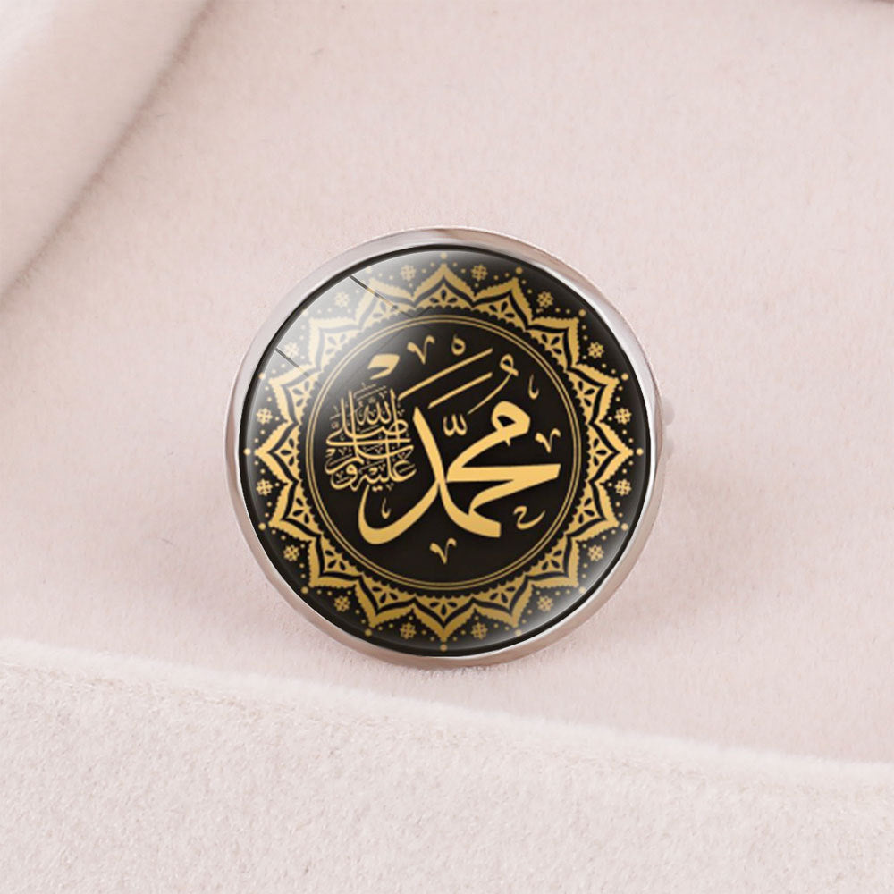 Islamic metal ring with geometric design and Arabic calligraphy.