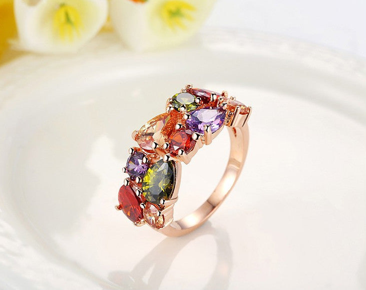 Colorful zircon ring with multi-colored stones on a gold band.