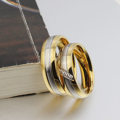 Titanium steel matching couple rings with geometric design on book.