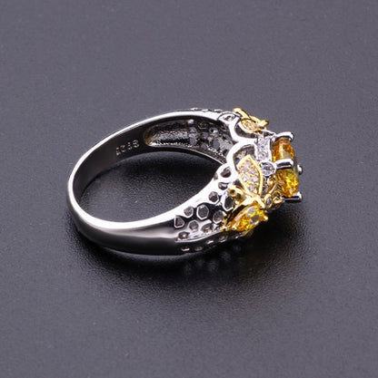 Alloy geometric zircon ring with yellow stone and intricate detailing.