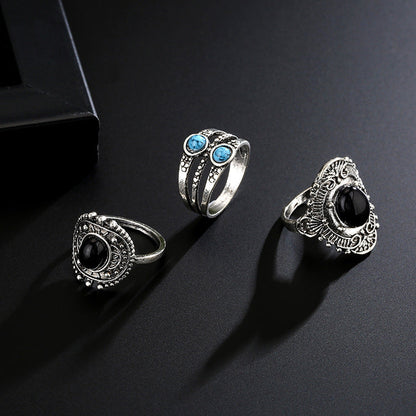 5-piece set of geometric alloy joint rings on black background.