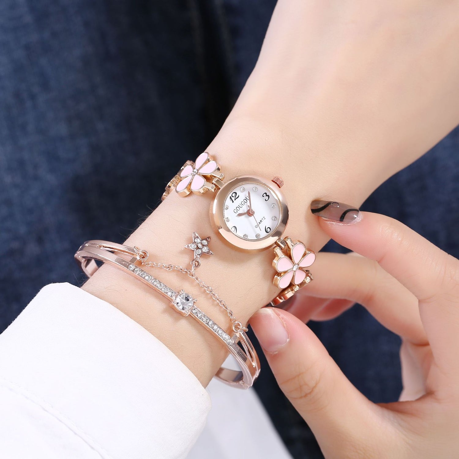 Ladies petal patterned quartz watch bracelet set worn on wrist.