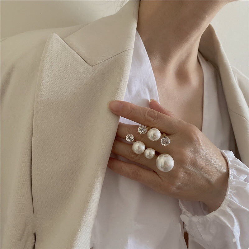 elegant multi pearl ring worn by woman in white blazer