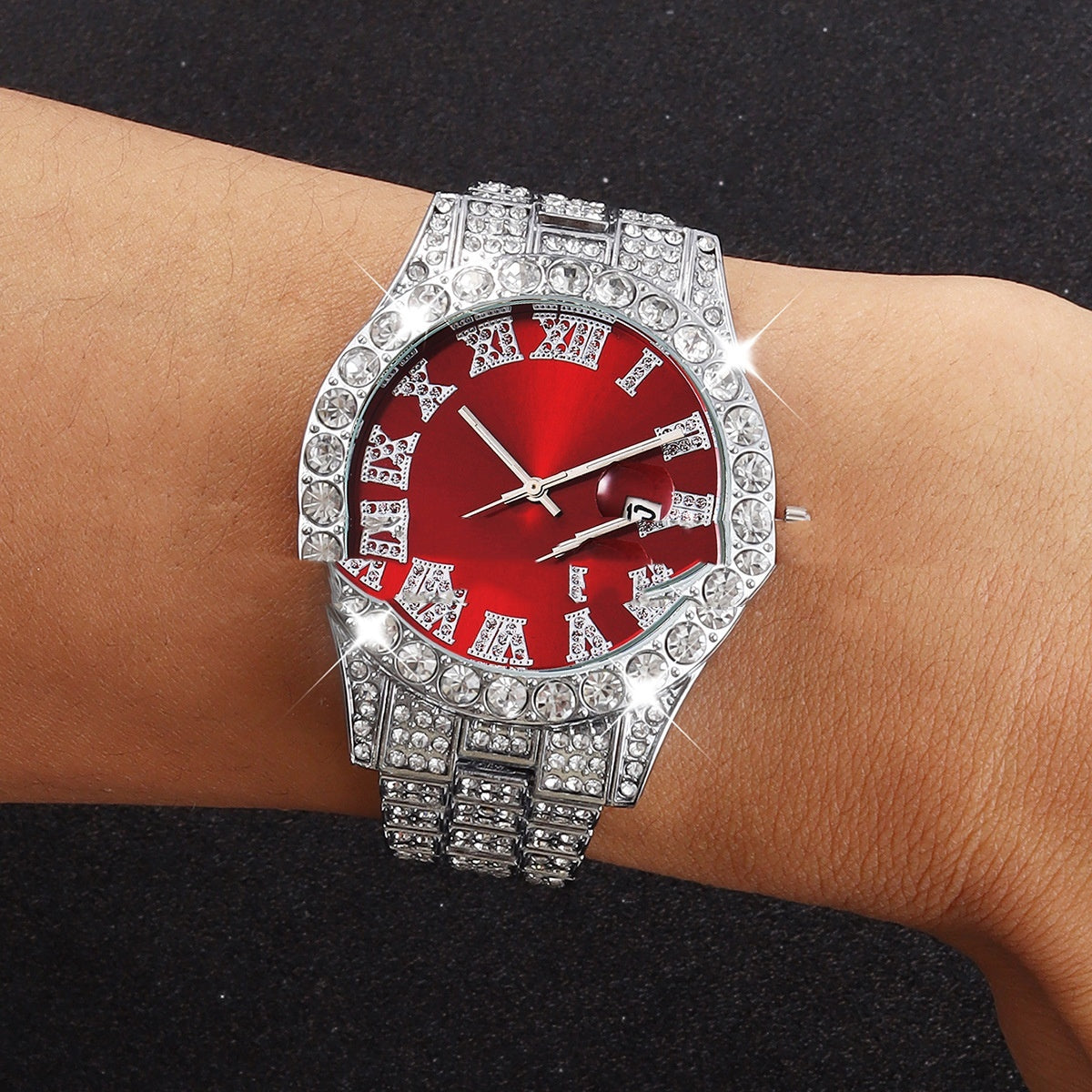 Red quartz watch with crystal embellishments on wrist.