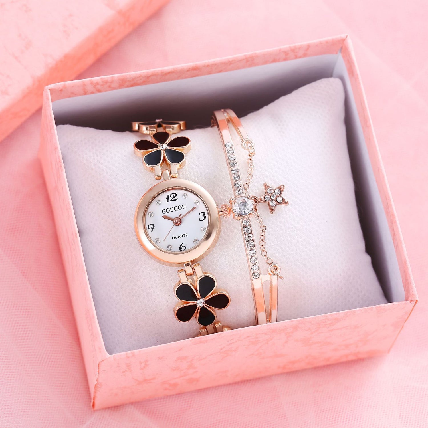 Ladies petal patterned quartz watch bracelet set in a pink box.