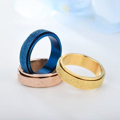 Rainbow bead fidget rings in titanium steel for stress relief, available in gold, blue, and rose gold.