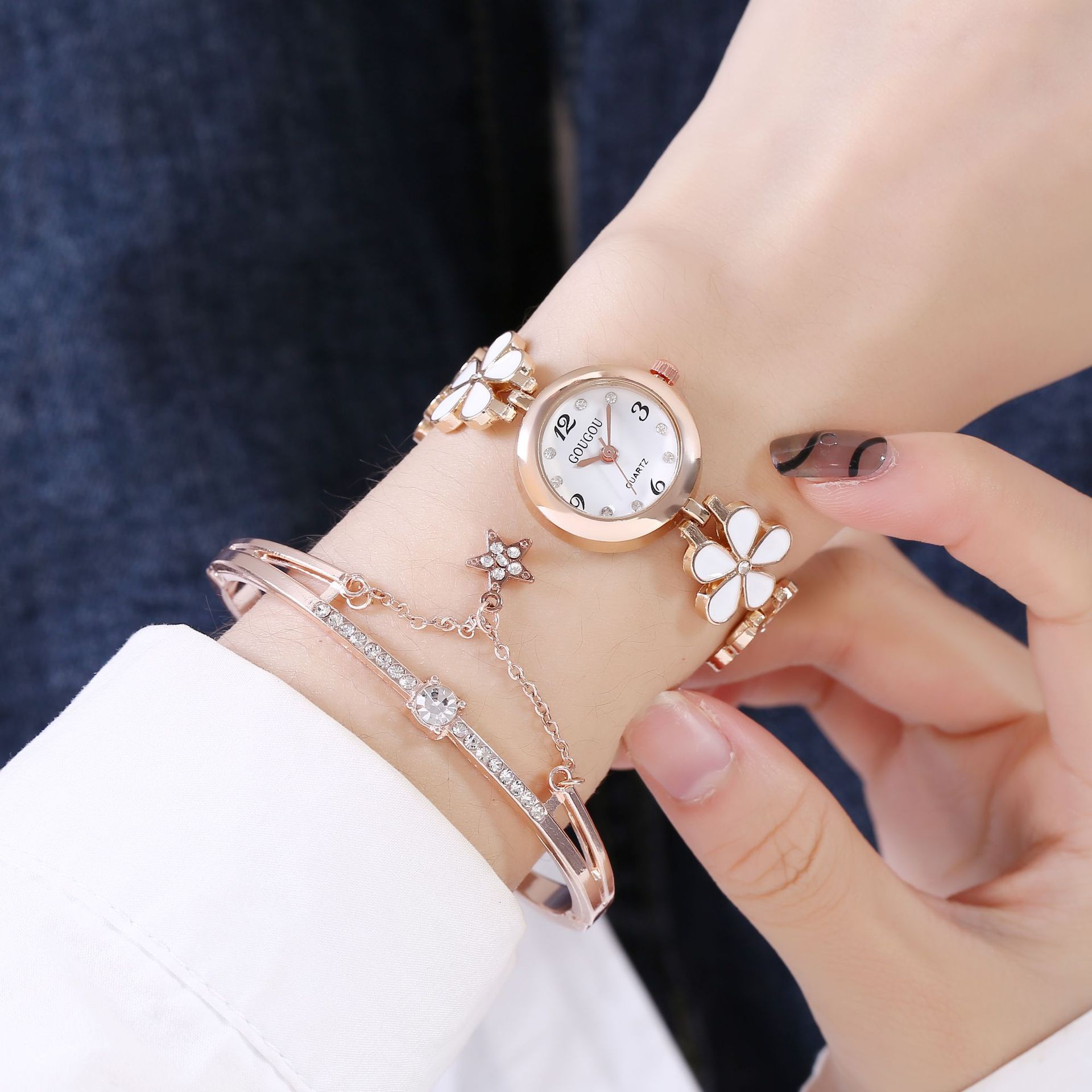 Ladies petal patterned quartz watch with floral bracelet set on wrist.