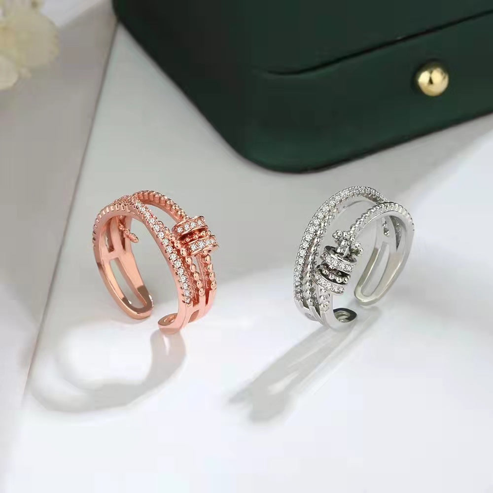 soothe anxiety rings in rose gold and silver with zircon inlay on white surface