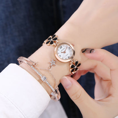 Ladies petal patterned quartz watch bracelet set on wrist.