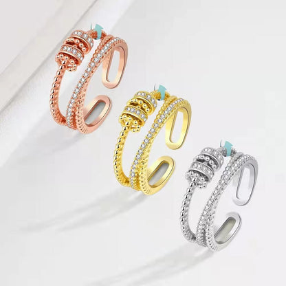 Soothe Anxiety Rings in rose gold, gold, and silver with geometric zircon details.